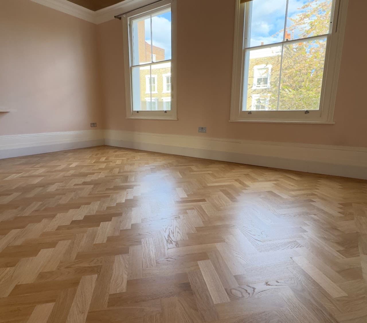 Freshly varnished herringbone parquet floor