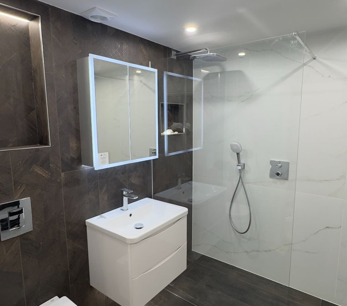 Compact bathroom with walk-in shower and wall-hung fittings
